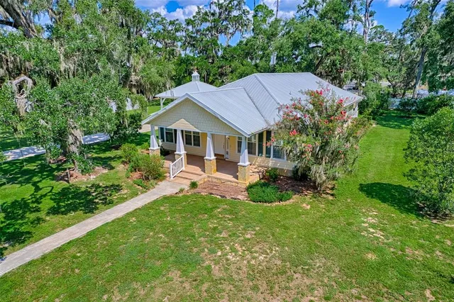 an aerial view of residential houses with outdoor space and street view