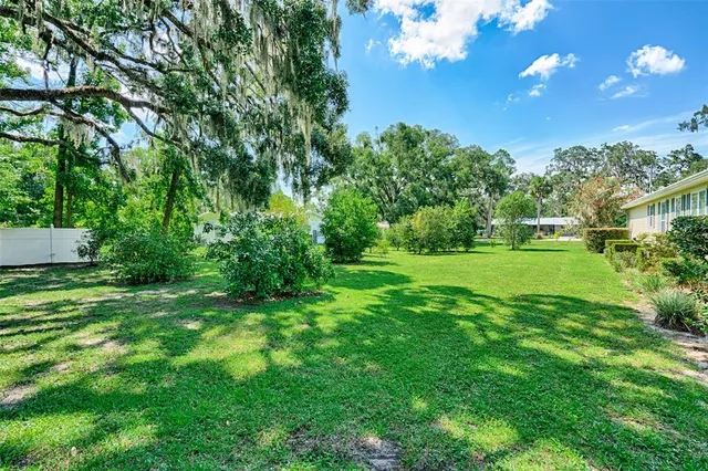 an aerial view of residential houses with outdoor space and street view