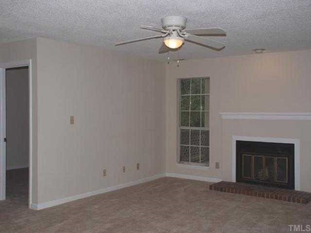 106 Choptank Court Cary, NC 27513 - Photo 2 of 12 an empty room with windows cabinet and fireplace