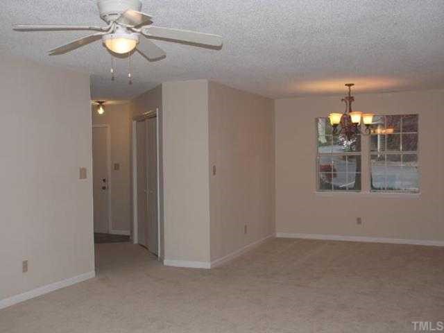 106 Choptank Court Cary, NC 27513 - Photo 4 of 12 a view of a room with a chandelier fan and wooden floor