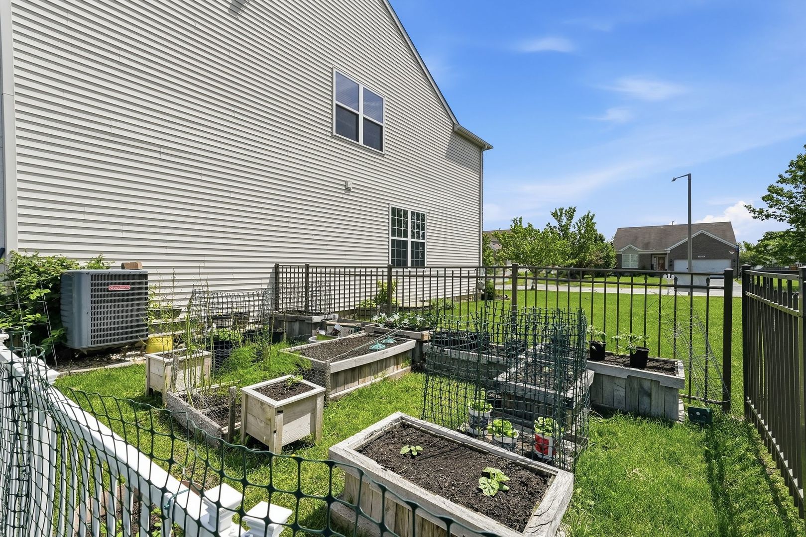 25216 Spring Street Manhattan, IL 60442 - Photo 18 of 28 a view of a chairs and table in backyard of the house