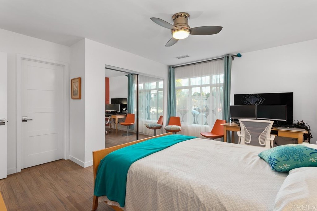 990 Laguna Drive Carlsbad, CA 92008 - Photo 11 of 21 a bedroom with bed and large windows