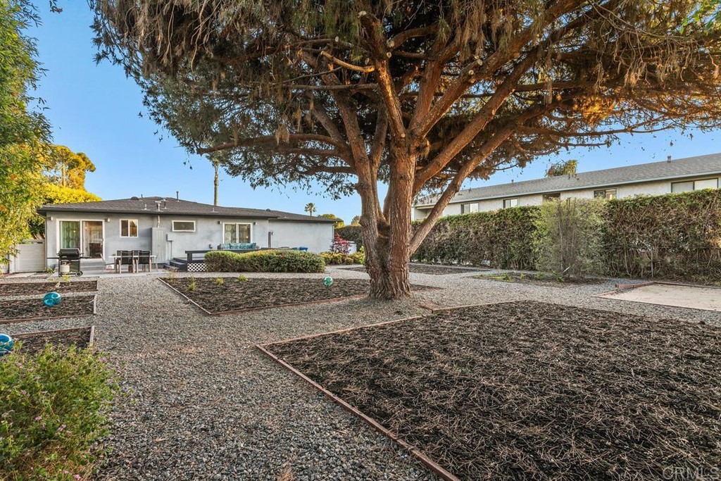 990 Laguna Drive Carlsbad, CA 92008 - Photo 16 of 21 a view of a house with a tree in the yard