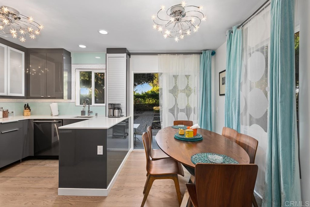 990 Laguna Drive Carlsbad, CA 92008 - Photo 5 of 21 a view of a dining room with furniture a chandelier and wooden floor