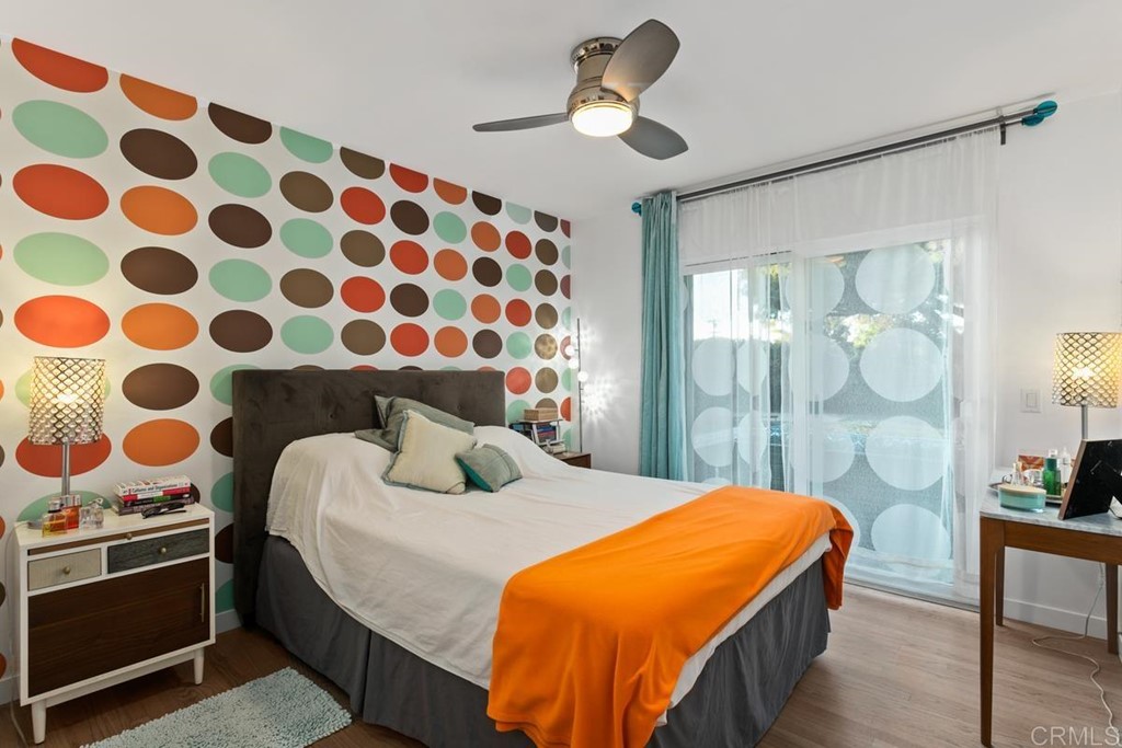 990 Laguna Drive Carlsbad, CA 92008 - Photo 10 of 21 a bedroom with a bed and a chandelier