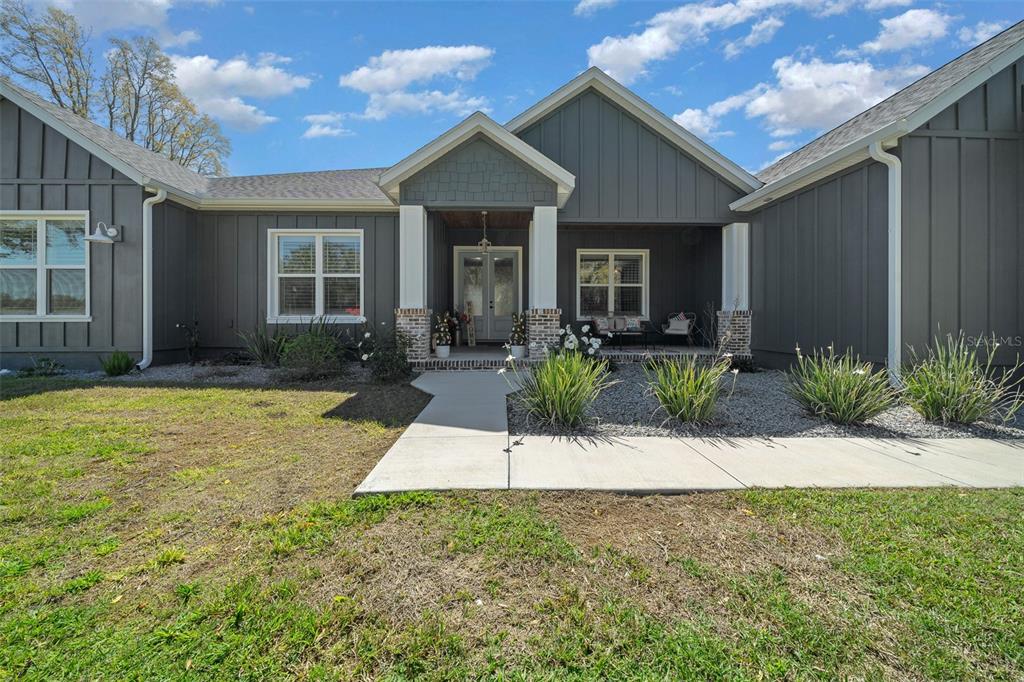 11707 Southeast 101st Court Road Belleview, FL 34420 - Photo 12 of 84 a view of house in front of house with porch