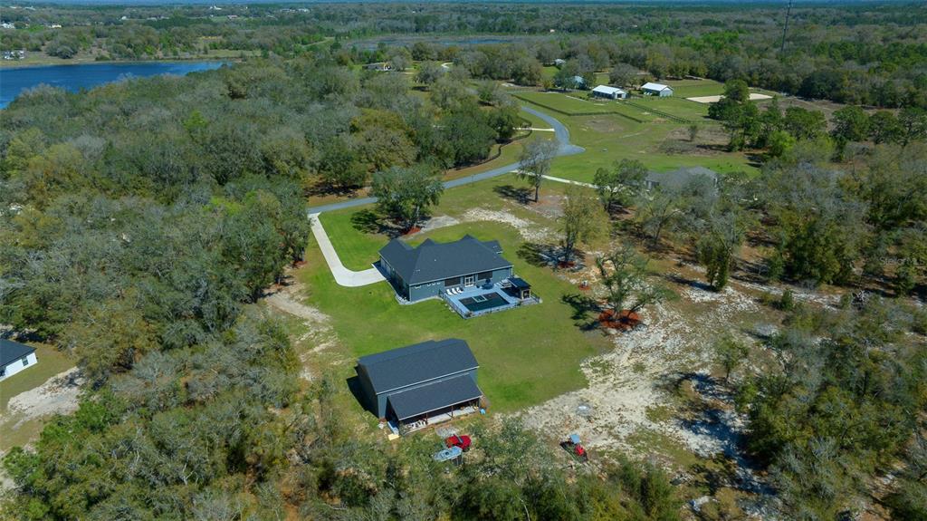 11707 Southeast 101st Court Road Belleview, FL 34420 - Photo 3 of 84 an aerial view of residential house with outdoor space and trees all around