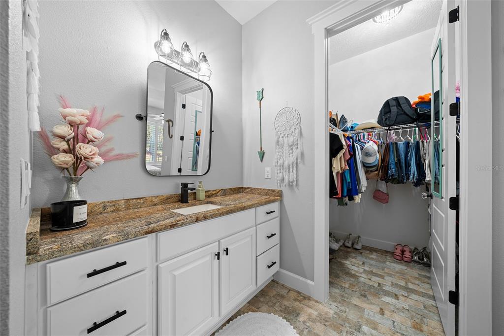 11707 Southeast 101st Court Road Belleview, FL 34420 - Photo 48 of 84 a bathroom with a double vanity sink and a mirror