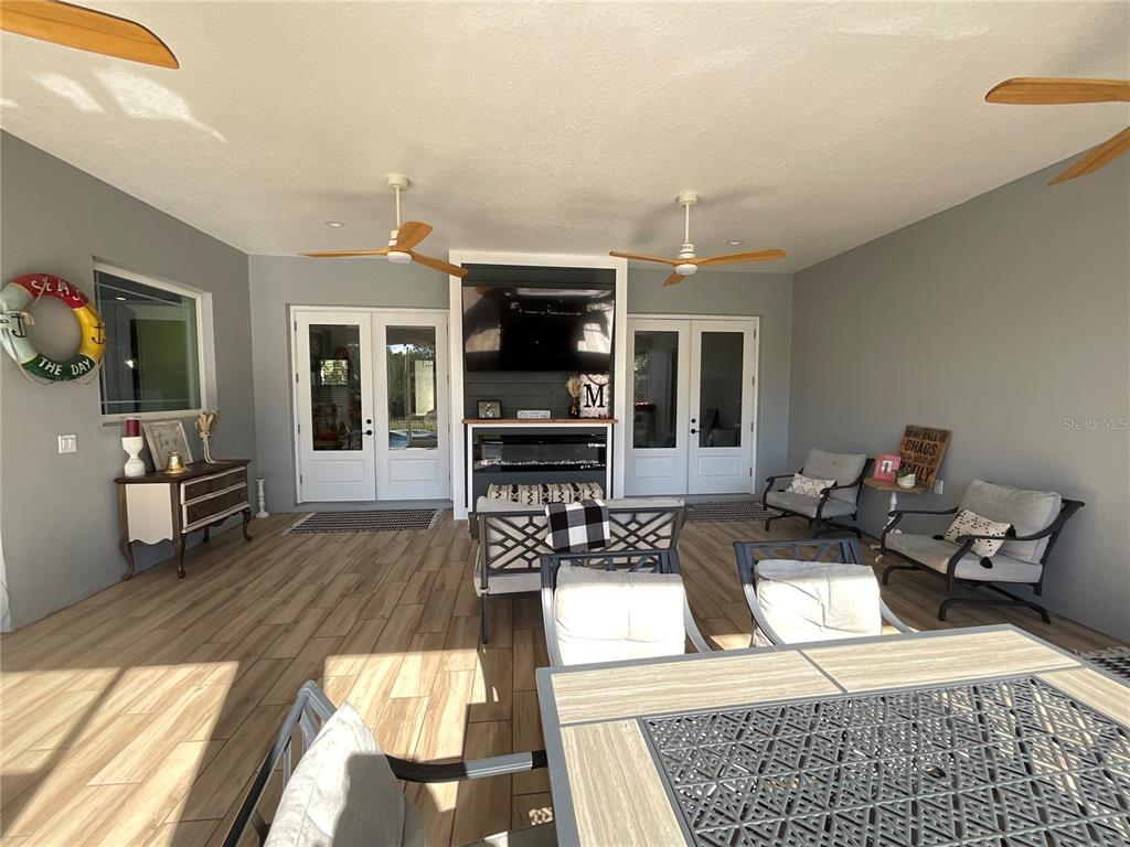 11707 Southeast 101st Court Road Belleview, FL 34420 - Photo 55 of 84 a living room with furniture a flat screen tv and kitchen view