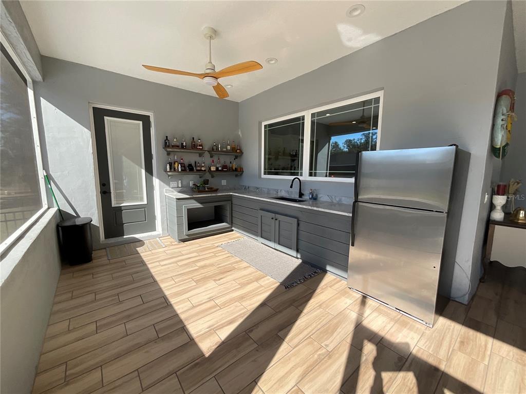 11707 Southeast 101st Court Road Belleview, FL 34420 - Photo 57 of 84 a kitchen with stainless steel appliances granite countertop a refrigerator stove microwave and sink