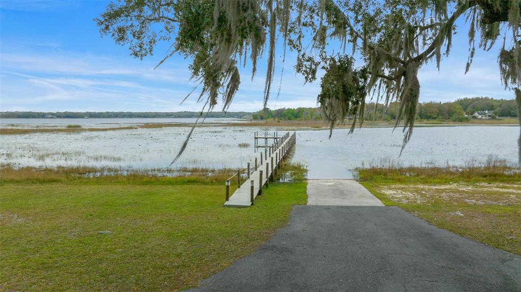 11707 Southeast 101st Court Road Belleview, FL 34420 - Photo 81 of 84 a view of a swimming pool with an outdoor space and seating area