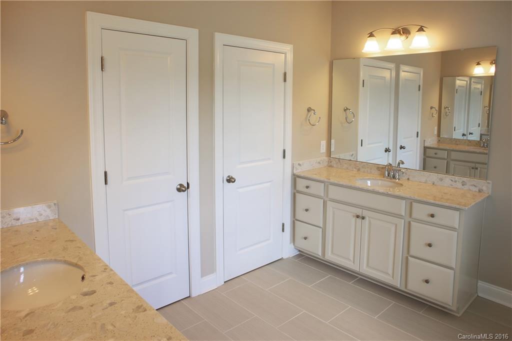 294 Helton Lane, Unit 8 Fort Mill, SC 29708 - Photo 14 of 19 a spacious bathroom with a granite countertop sink a mirror and a