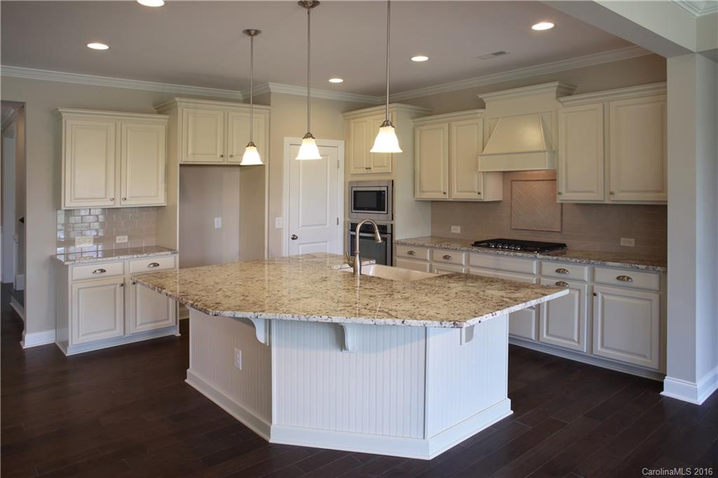 294 Helton Lane, Unit 8 Fort Mill, SC 29708 - Photo 3 of 19 a kitchen with stainless steel appliances granite countertop a sink a stove and a refrigerator