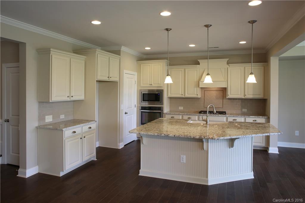 294 Helton Lane, Unit 8 Fort Mill, SC 29708 - Photo 5 of 19 a large kitchen with kitchen island a sink stainless steel appliances and cabinets