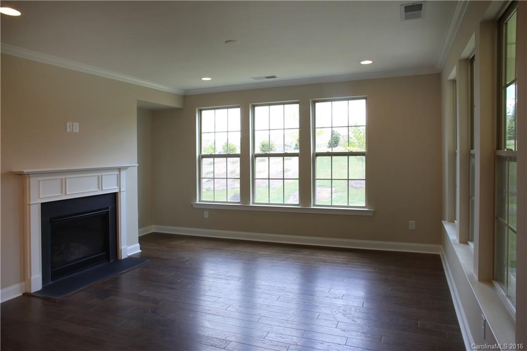294 Helton Lane, Unit 8 Fort Mill, SC 29708 - Photo 8 of 19 an empty room with wooden floor fireplace and windows