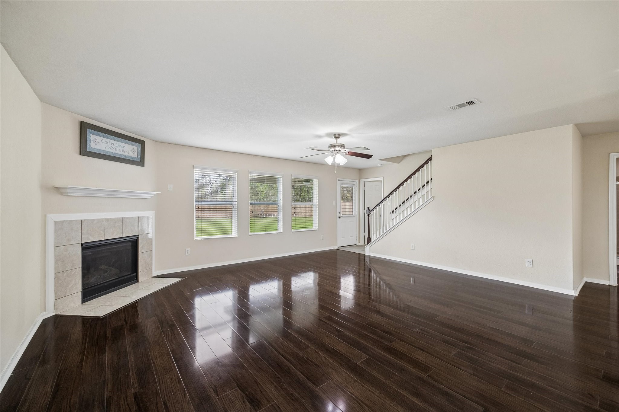 15642 South Fall Fern Circle Houston, TX 77044 - Photo 3 of 32 a view of an empty room with wooden floor fireplace and a window