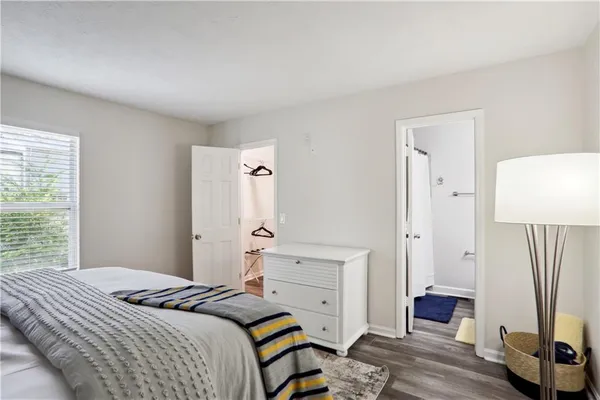 a bedroom with a bed and a mirror