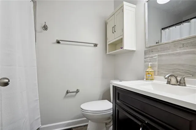 a bathroom with a sink toilet and vanity