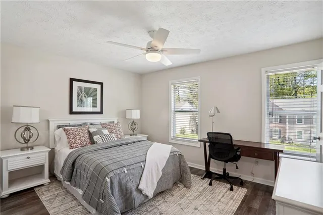 a bedroom with a bed a table and chair