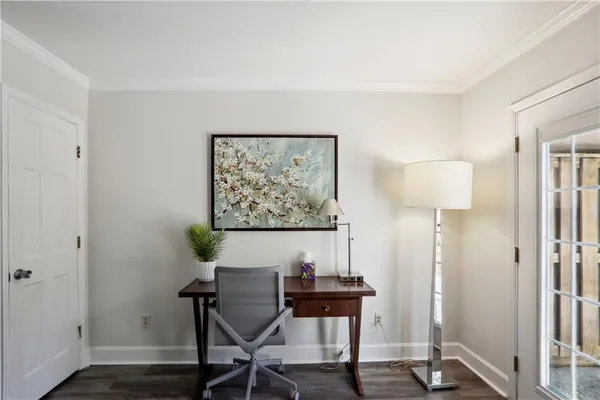 a view of a workspace with furniture and wooden floor