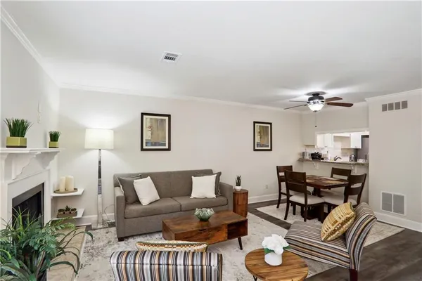 a living room with furniture a fireplace and a flat screen tv