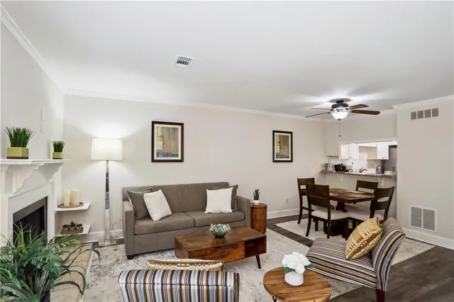 a living room with furniture a fireplace and a flat screen tv