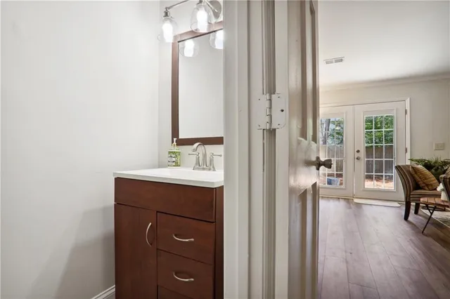 a en suite bathroom with a sink a mirror and a bathtub
