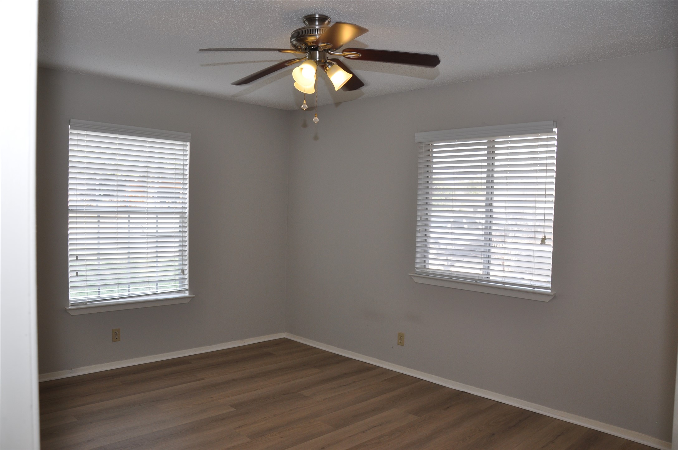 2011 Gathright Cove, Unit A Austin, TX 78704 - Photo 14 of 17 a view of an empty room with wooden floor and a window