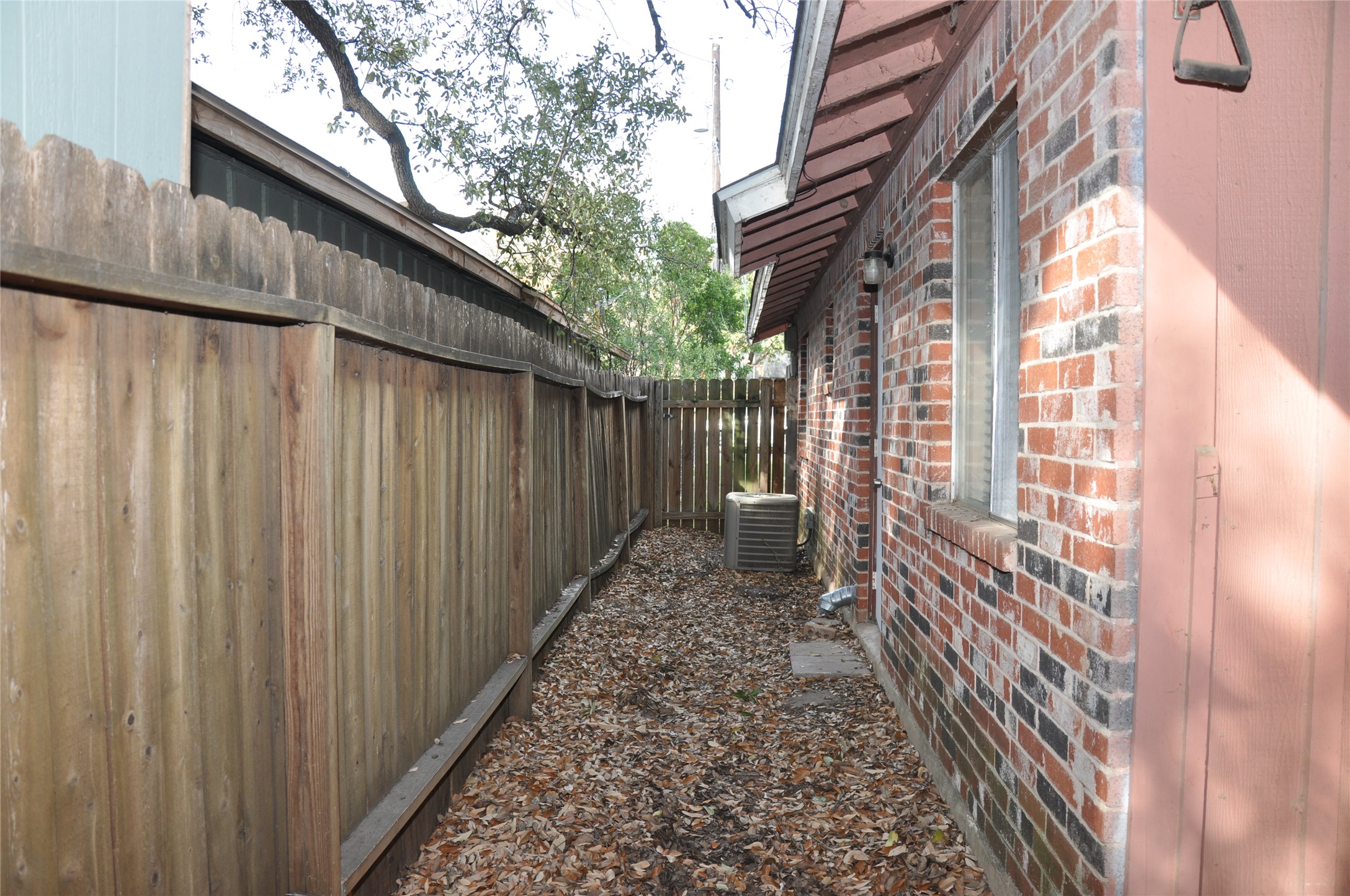 2011 Gathright Cove, Unit A Austin, TX 78704 - Photo 16 of 17 a view of a pathway of a building with wooden fence