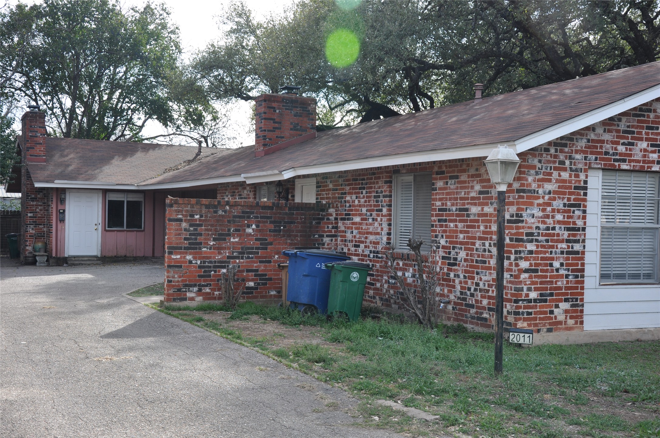 2011 Gathright Cove, Unit A Austin, TX 78704 - Photo 2 of 17 a brick building with a bench in front of it