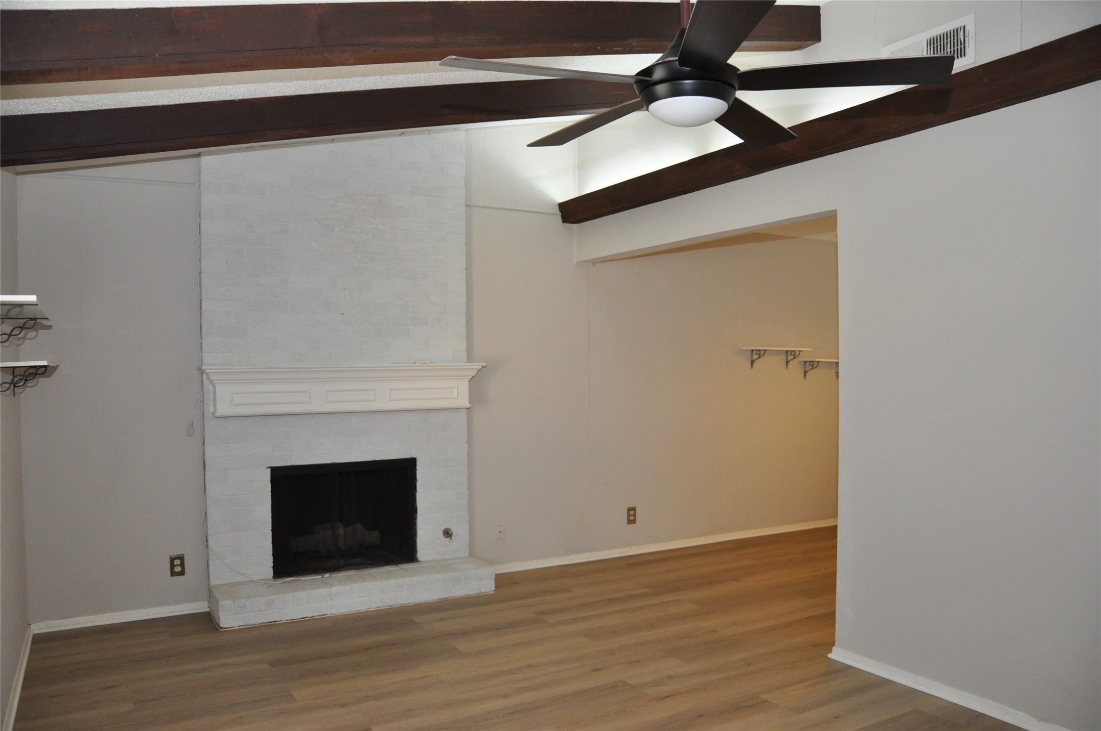 2011 Gathright Cove, Unit A Austin, TX 78704 - Photo 4 of 17 a view of a livingroom with wooden floor a fireplace