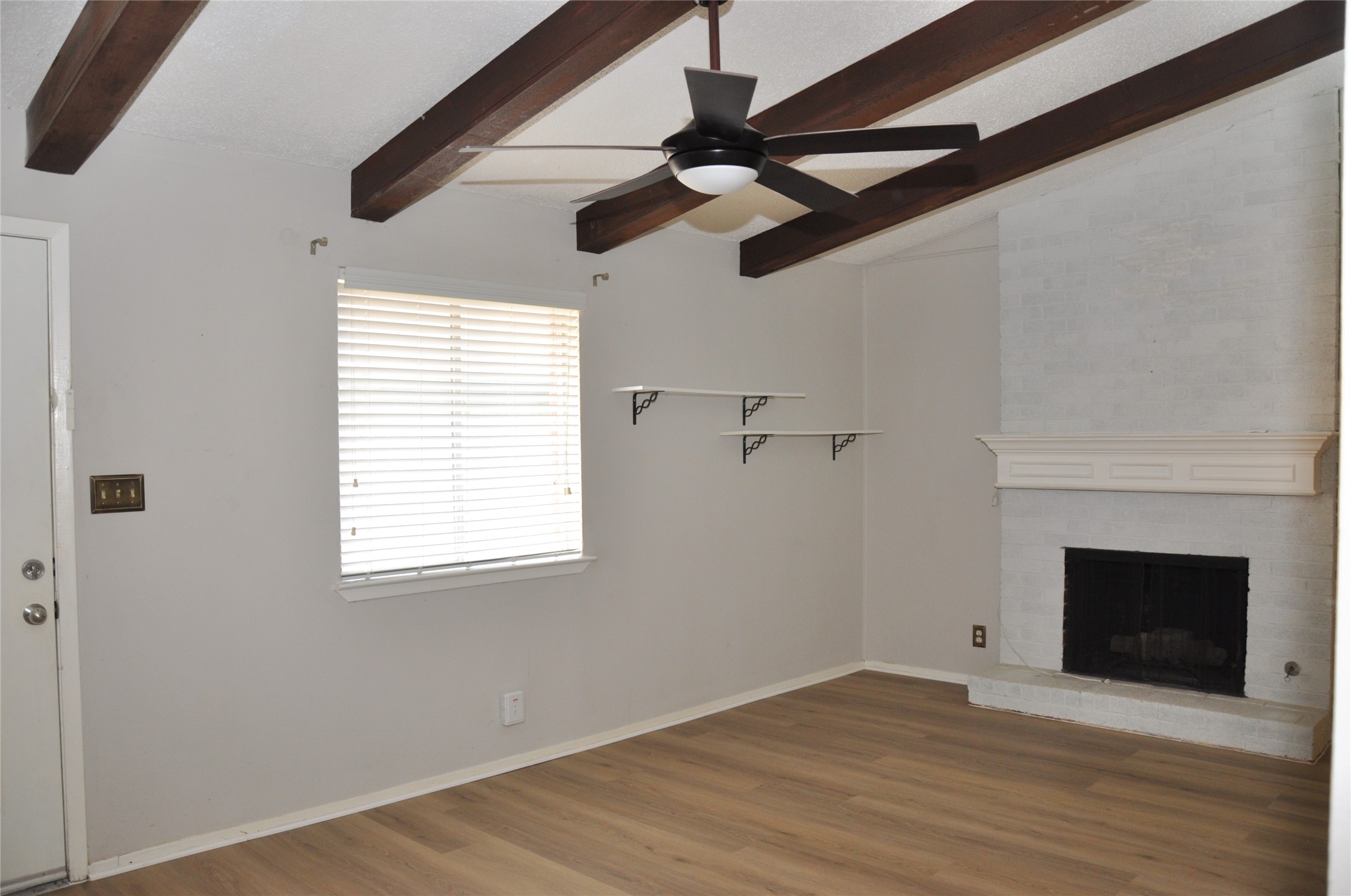 2011 Gathright Cove, Unit A Austin, TX 78704 - Photo 5 of 17 a view of empty room with wooden floor and fireplace