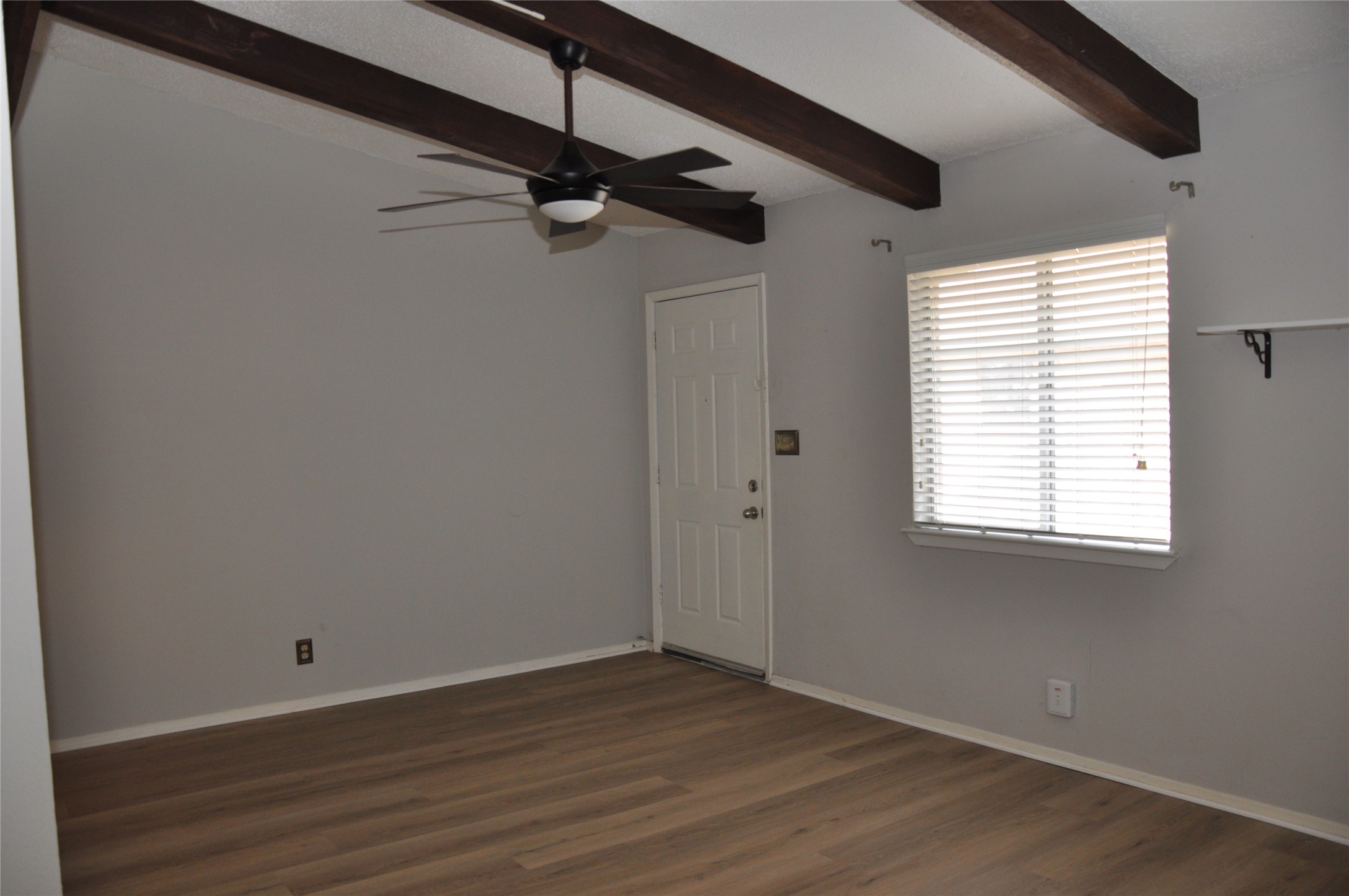 2011 Gathright Cove, Unit A Austin, TX 78704 - Photo 6 of 17 a view of an empty room with wooden floor and a window