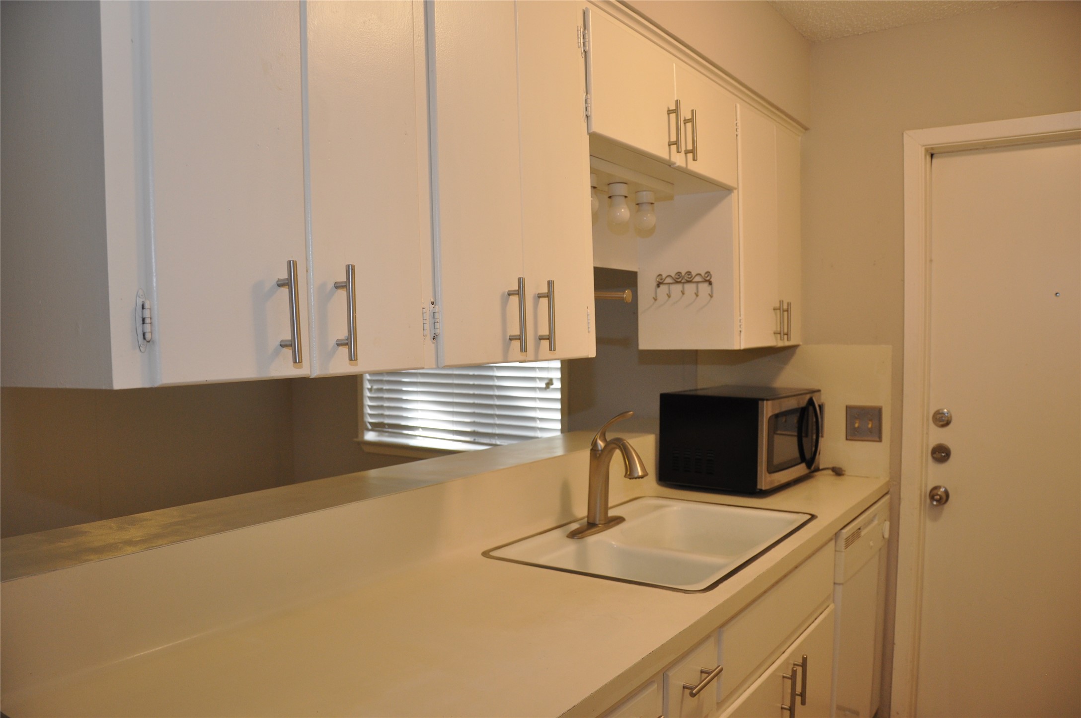 2011 Gathright Cove, Unit A Austin, TX 78704 - Photo 10 of 17 a kitchen with a sink and a refrigerator