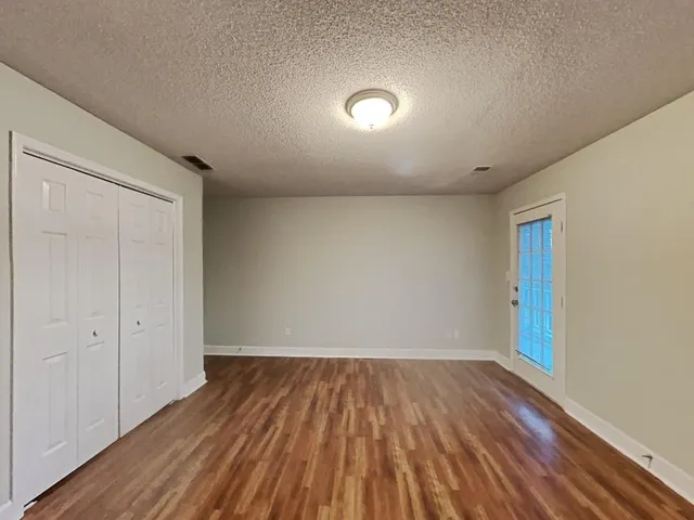 a view of room with wooden floor
