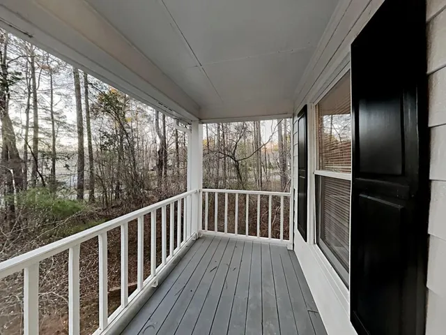 a view of balcony with wooden floor