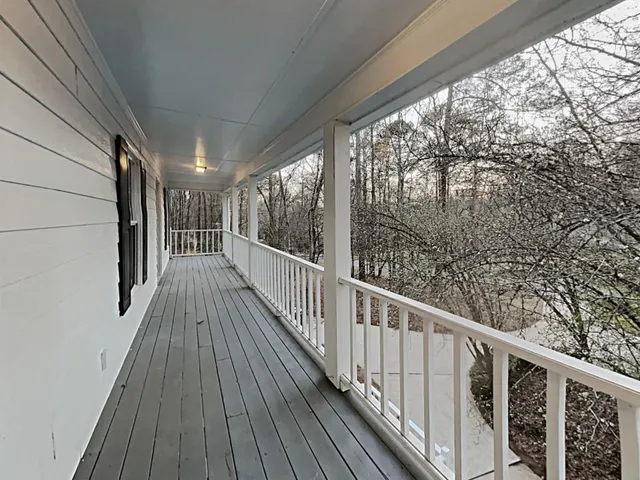 a view of balcony with wooden floor
