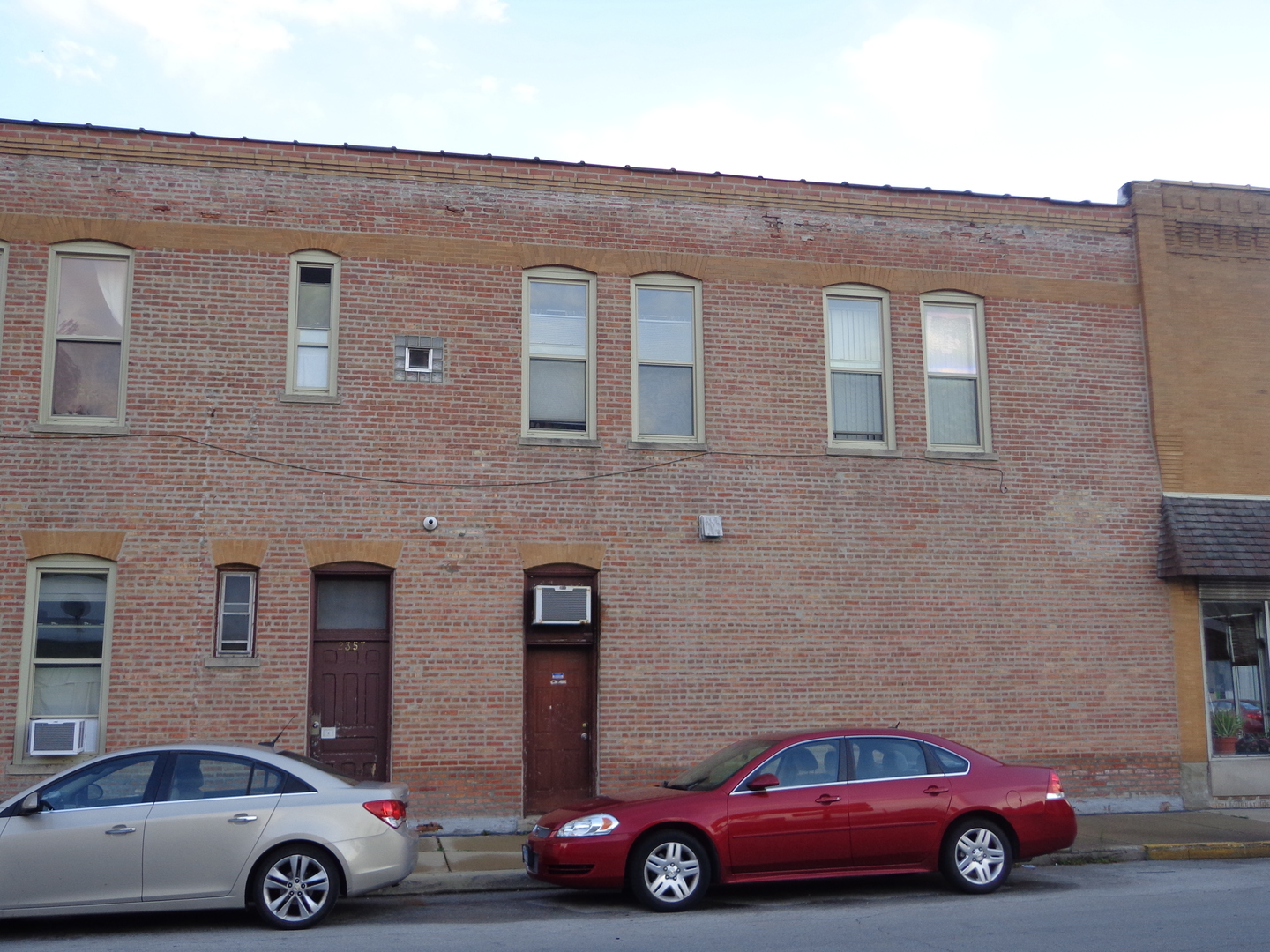 2357 Walnut Street, Unit 3 Blue Island, IL 60406 - Photo 2 of 16 a car parked in front of a brick house
