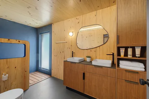 a bathroom with a sink mirror and vanity