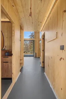 a view of a hallway with wooden shelves