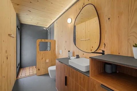 a bathroom with a sink a toilet and a mirror