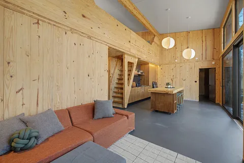 a living room with furniture a mirror and a shower