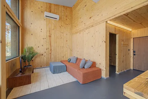 a spacious bedroom with a bed and a couch