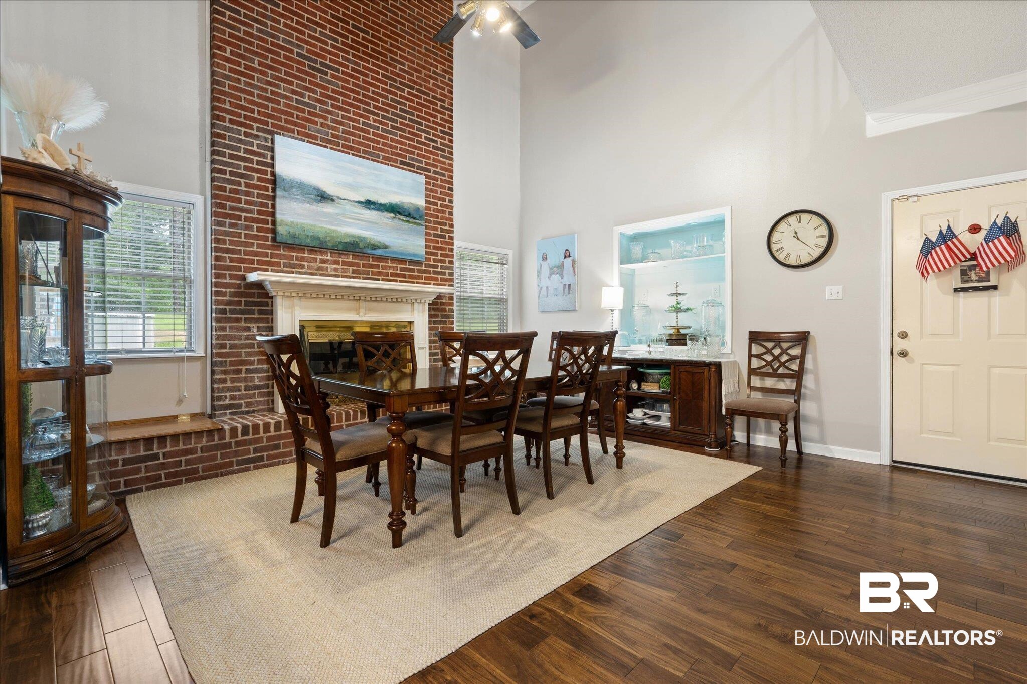 2300 Radcliff Road Saraland, AL 36571 - Photo 9 of 56 Dining space with a towering ceiling, wood finished floors, a brick fireplace, and a ceiling fan