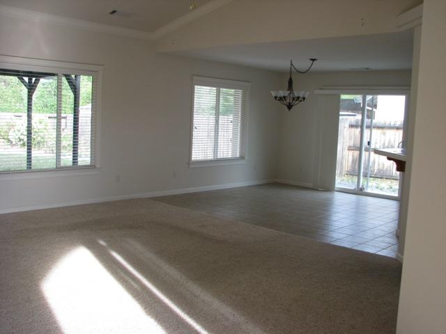 7550 Pit Road Redding, CA 96001 - Photo 4 of 20 an empty room with wooden floor and windows