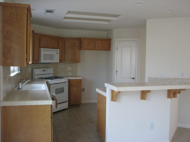 7550 Pit Road Redding, CA 96001 - Photo 7 of 20 a kitchen with a stove top oven and sink