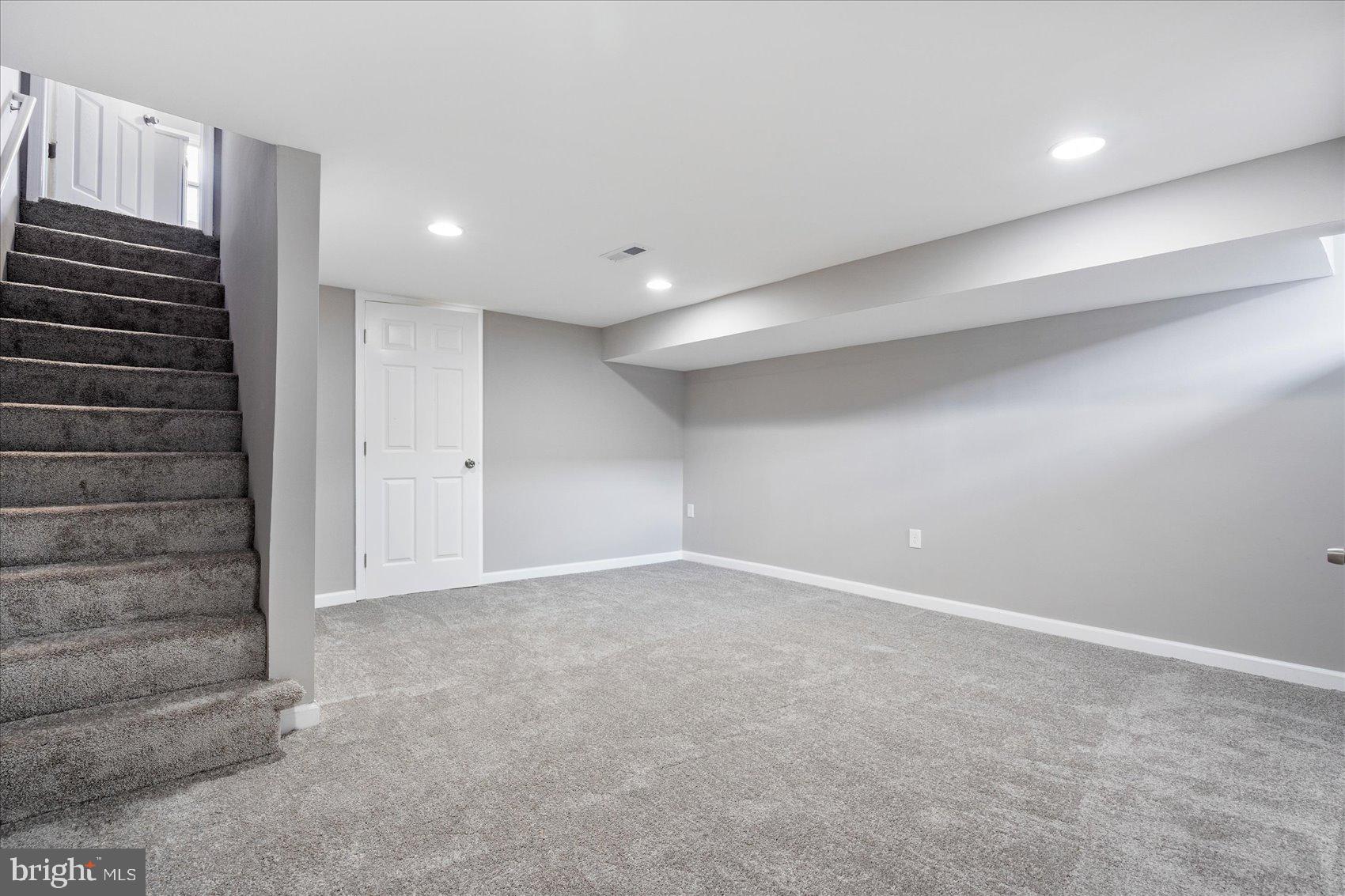 1932 Haselmere Road Dundalk, MD 21222 - Photo 27 of 40 a view of an empty room with wooden walls and stairs
