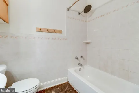 a bathroom with a bathtub and toilet