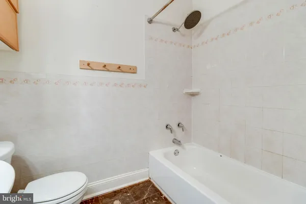 a bathroom with a bathtub and toilet