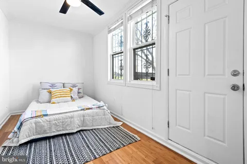 a bedroom with a bed and wooden floor